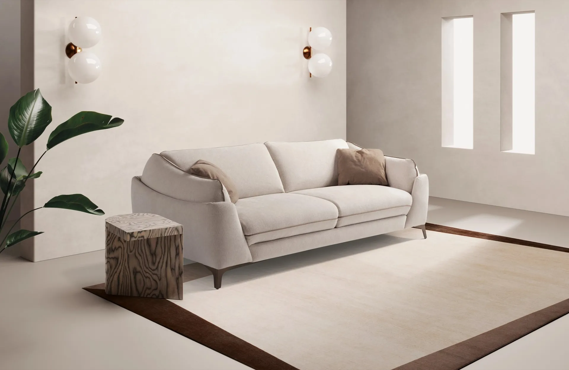 Divano letto Dune Dienne bianco crema con cuscini tortora in un soggiorno con pianta e applique