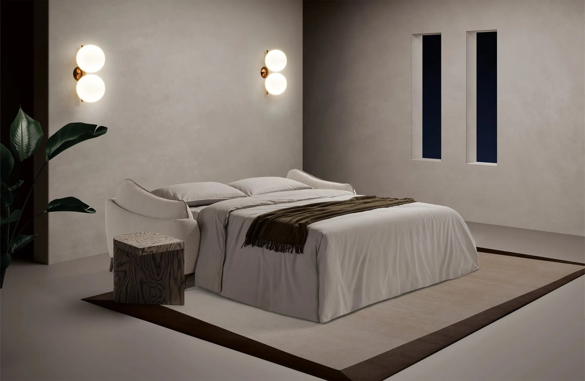 Divano letto Dune Dienne aperto di notte con coperta marrone