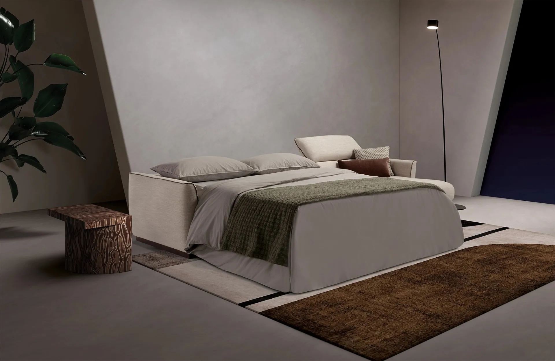 Divano letto Fellini Dienne aperto di notte con coperta verde