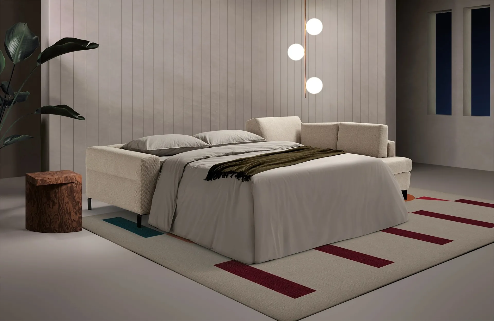 Divano letto Life Dienne aperto accanto all'elemento angolare, con coperta verde