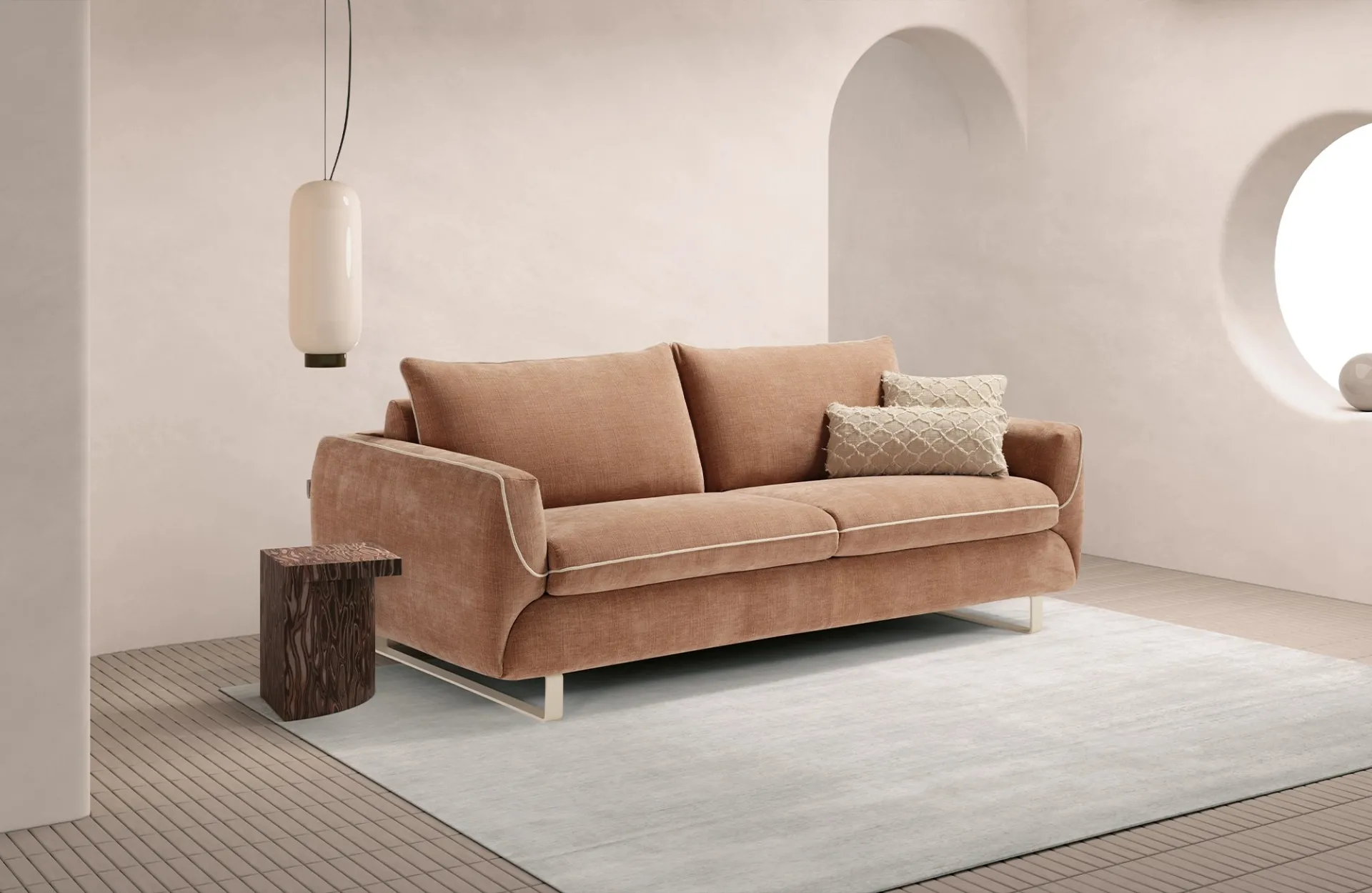 Divano letto Cannes Dienne color rosa cipria con profili chiari in una stanza con oblò