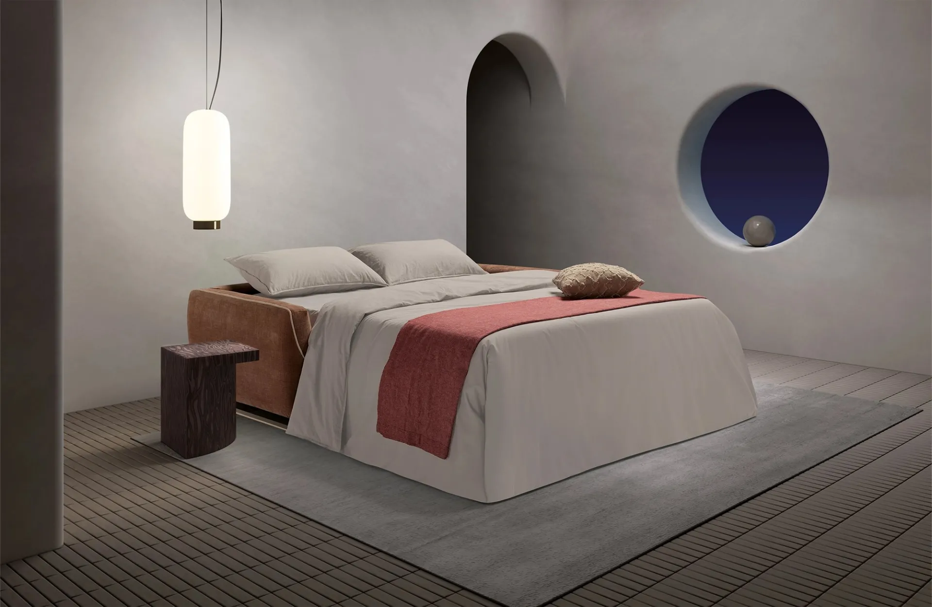 Divano letto Cannes Dienne aperto con coperta rossa, di notte