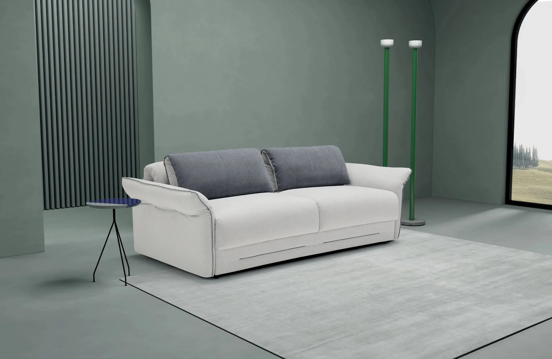 Divano letto Deep Dienne bianco con schienali grigi in una stanza verde con lampade a stelo