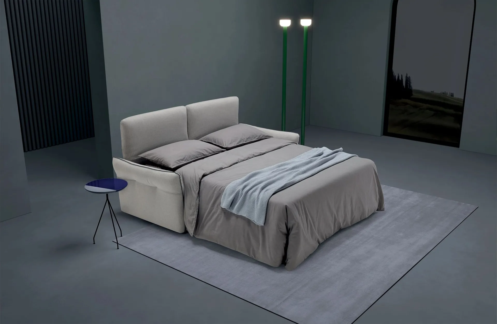 Divano letto Deep Dienne aperto con lenzuola grigie e plaid azzurro