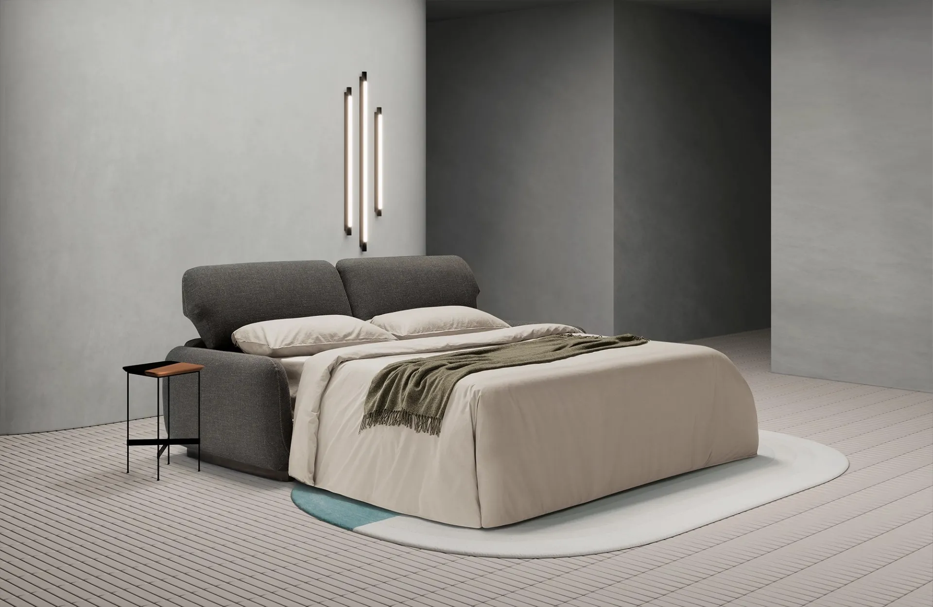 Divano letto Bob Dienne aperto con lenzuola beige e plaid verde