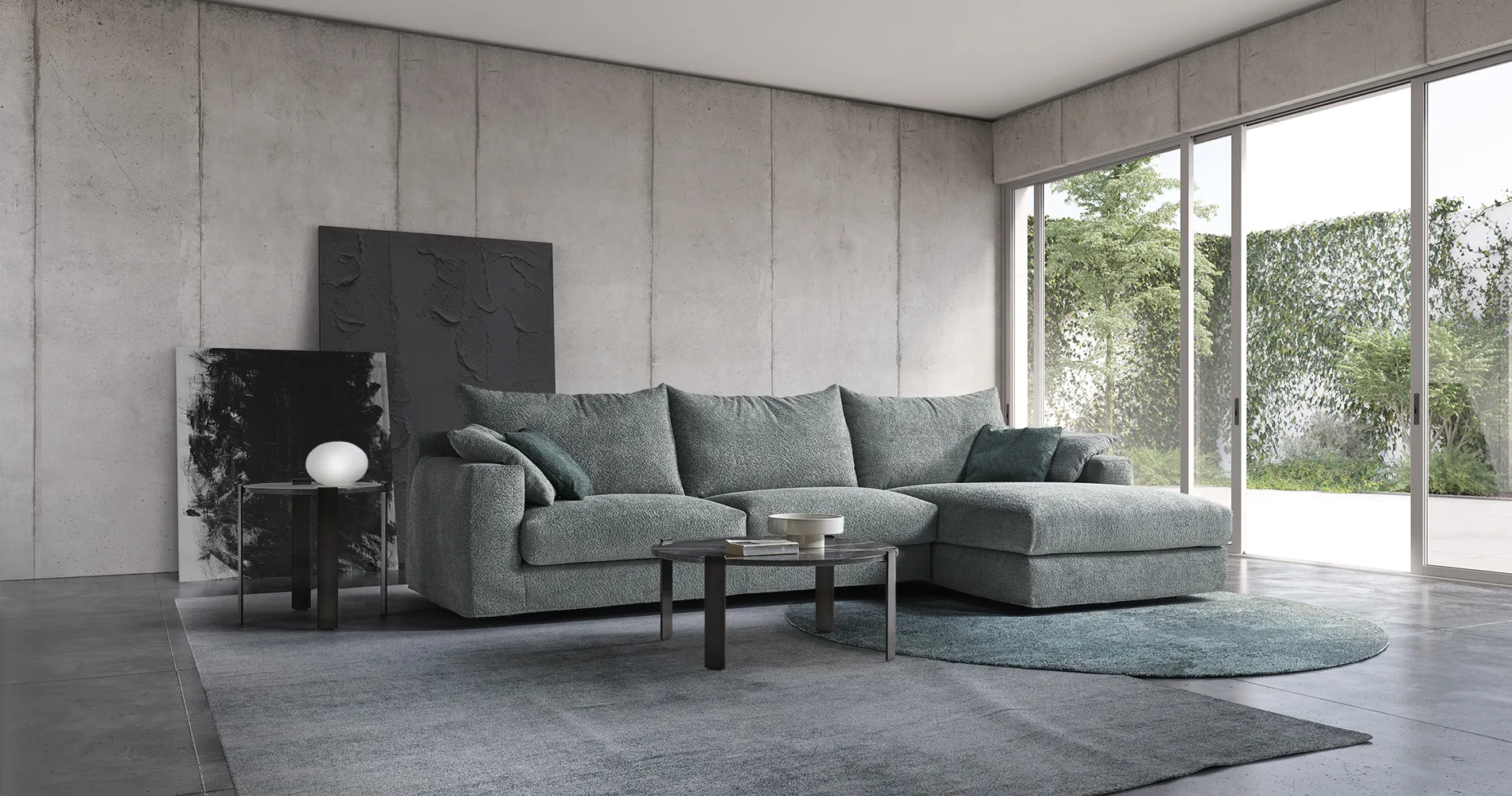 Divano Dress Rosini verde salvia ad angolo in un soggiorno con vetrata