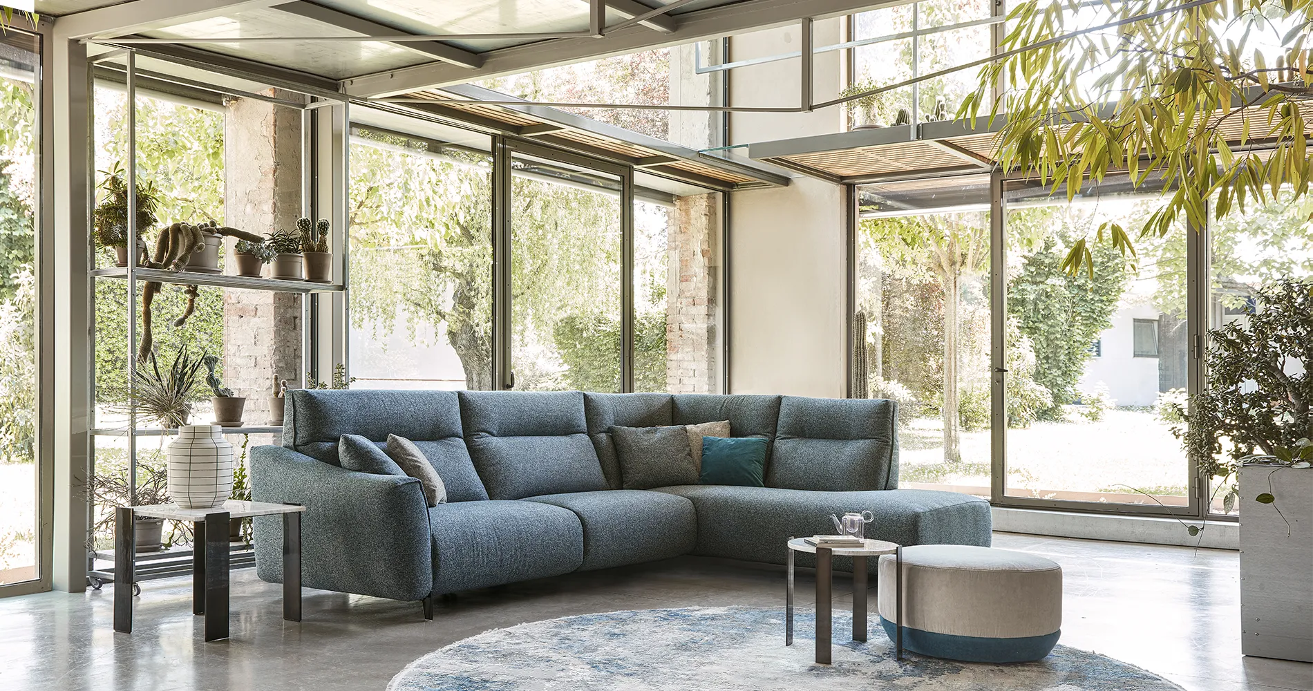 Divano angolare Madrid Rosini blu in una veranda luminosa