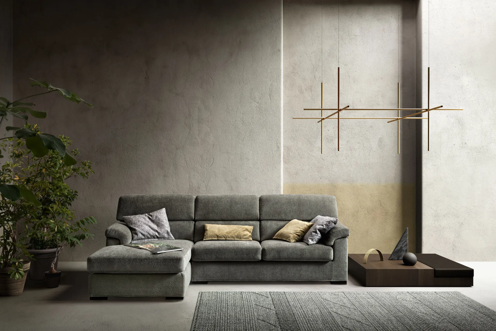 Divano componibile Star Samoa grigio con chaise longue, sotto una lampada a bracci dorati