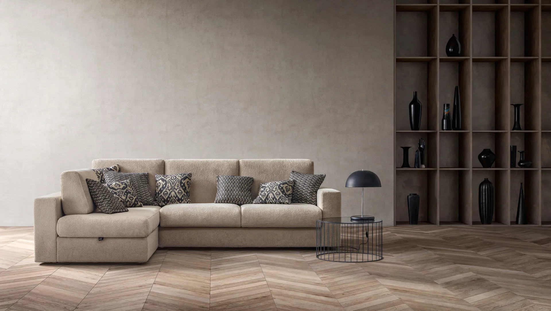 Divano letto Cliff Samoa beige con penisola e cuscini fantasia, su parquet a spina