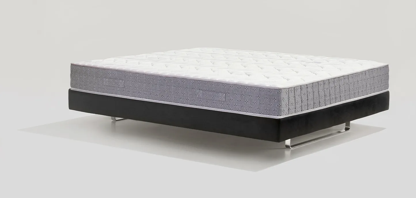 Materasso Riposo 9 Evo Magniflex di tre quarti con fascia grigia e piano bianco